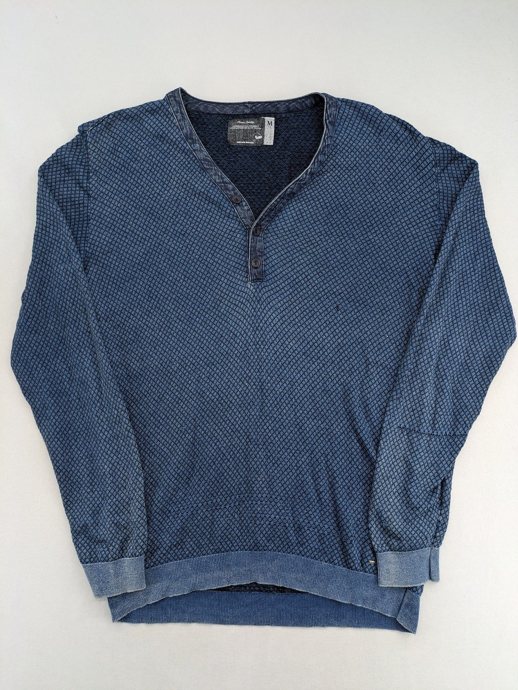 Gas blue turtle neck jumper with diamond pattern, three-button Henley neck, and contrasting trim.