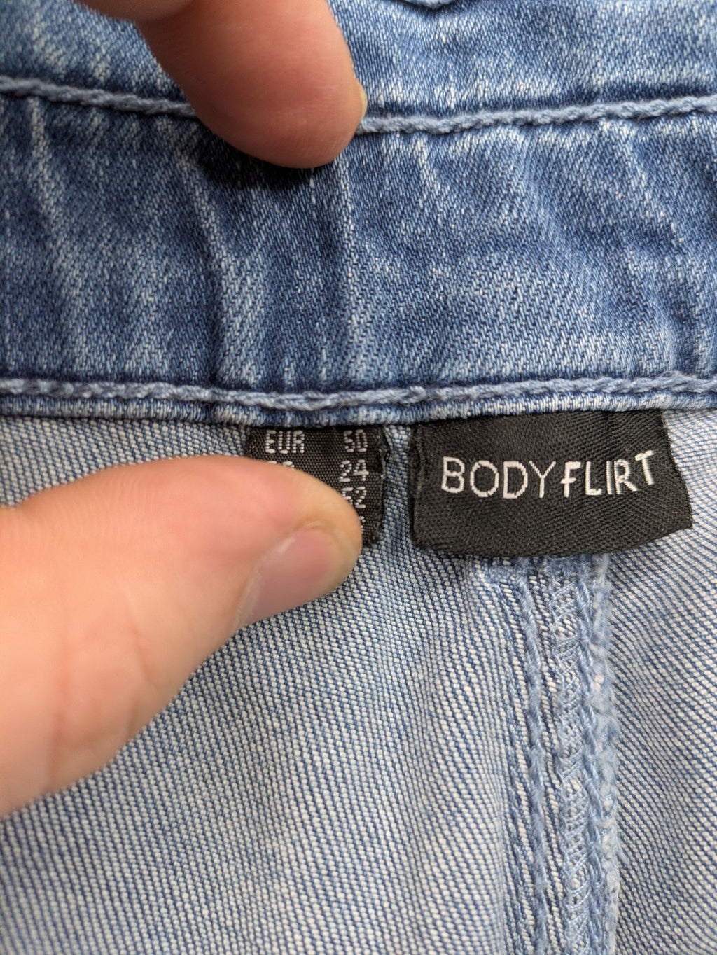 Bodyflirt blue high waist paperbag jeans shorts with button fly and rolled cuffs.