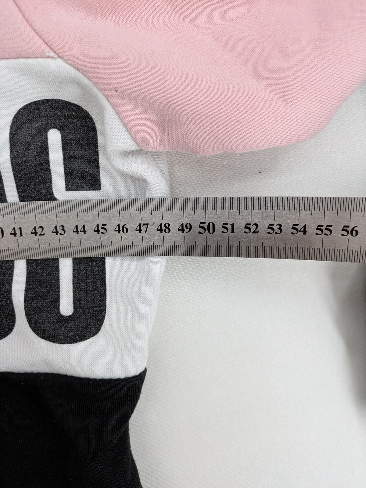 FB Sister multi hoodie colorblock design pink, white, black with "COURAGEOUS" graphic print.