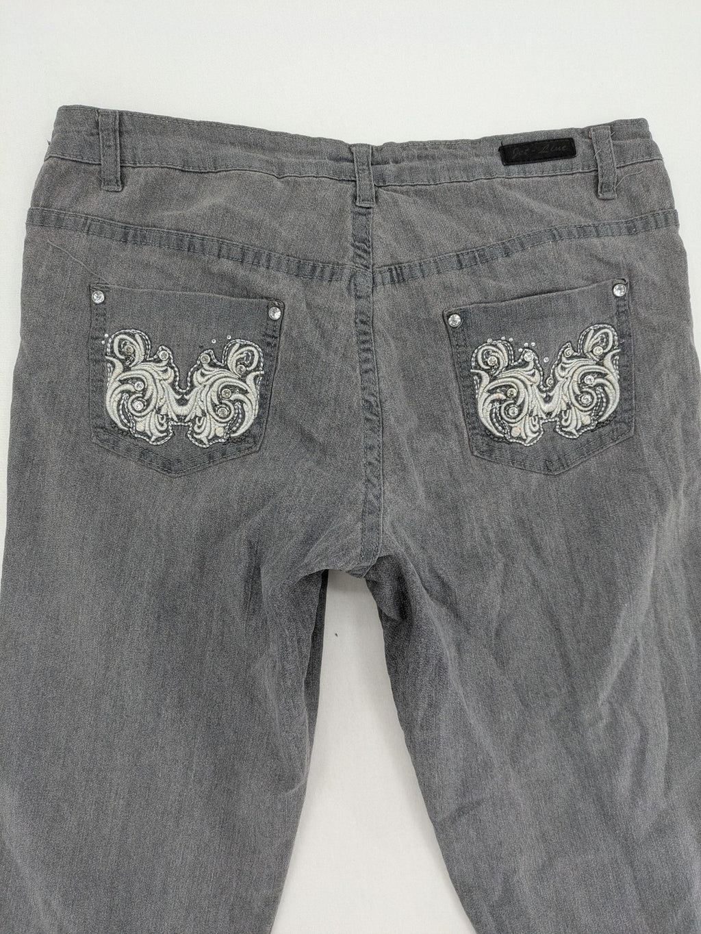 Jet Line grey straight jeans with embellished back pockets and frayed hem details.