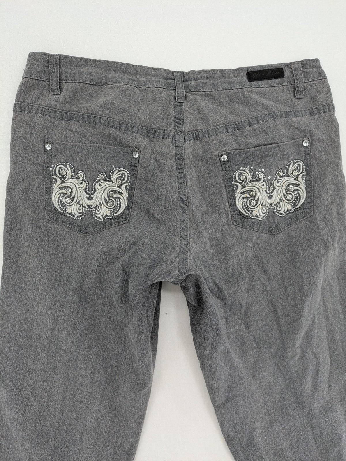Jet Line grey straight jeans with embellished back pockets and frayed hem details.