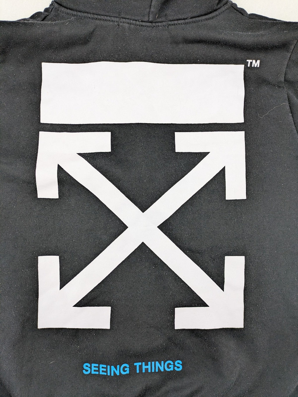 Off-White white zip-through hoodie with diagonal stripes and large arrows graphic.