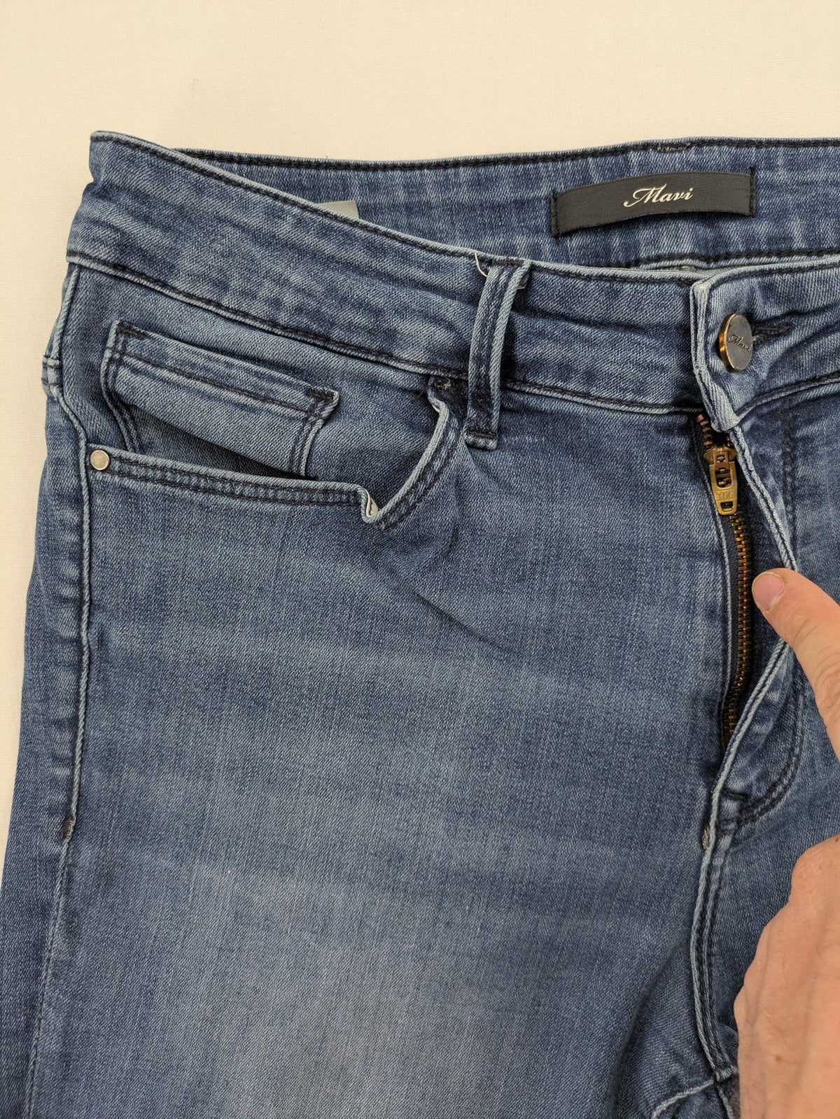 Mavi blue high rise super skinny jeans with medium wash and stretch denim material.