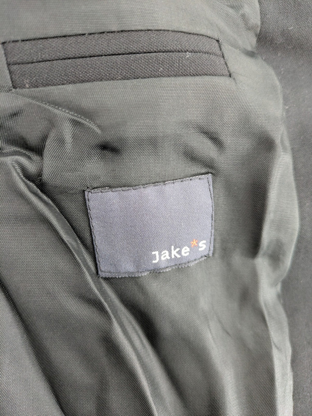 Jake*s pink jacket classic design with falling lapel and three-button closure.
