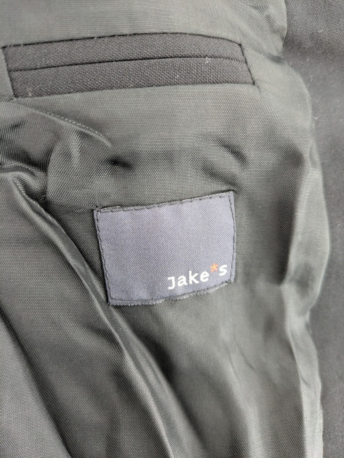 Jake*s pink jacket classic design with falling lapel and three-button closure.