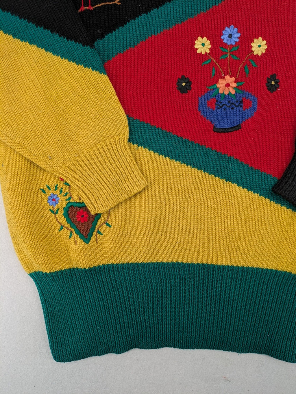 Pullover multi knit jumper featuring colorful block pattern and embroidered rooster and flowers.