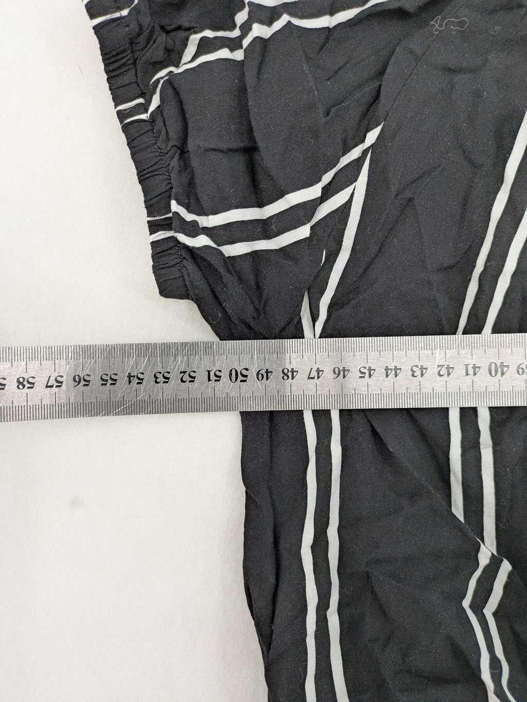 Hailys black and white striped crop top with front tie and off-shoulder design.
