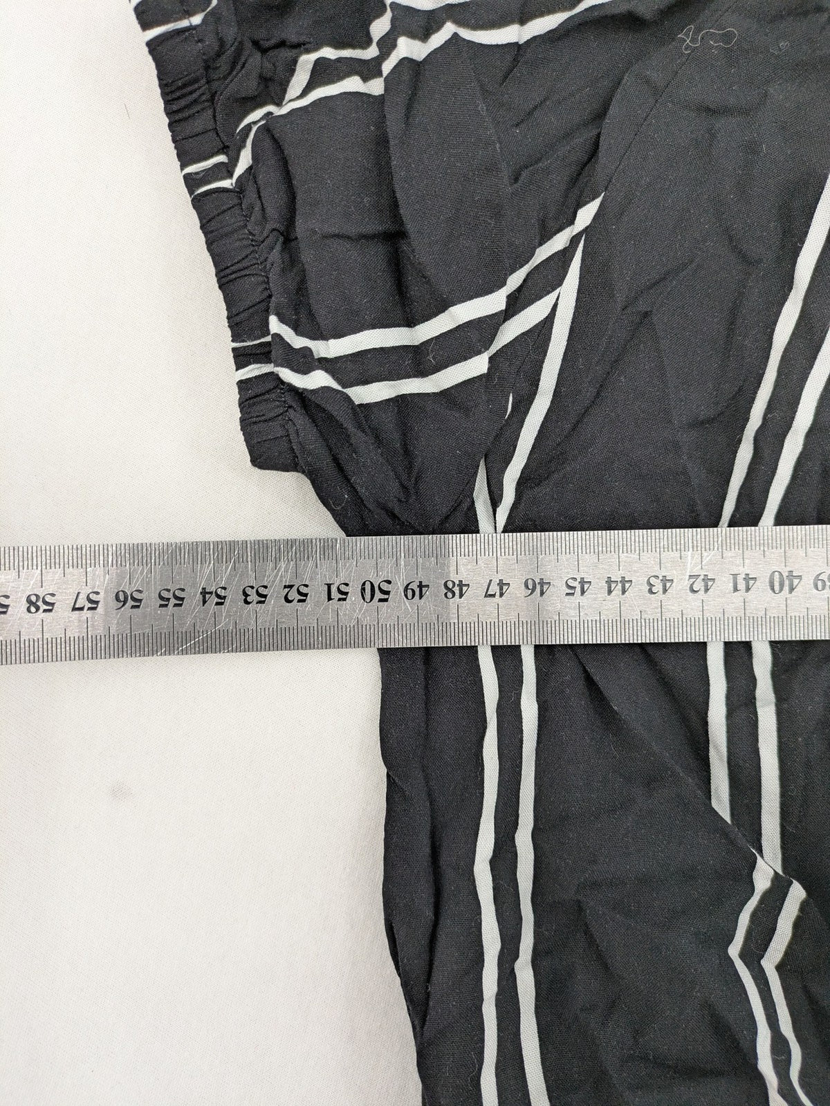 Hailys black and white striped crop top with front tie and off-shoulder design.