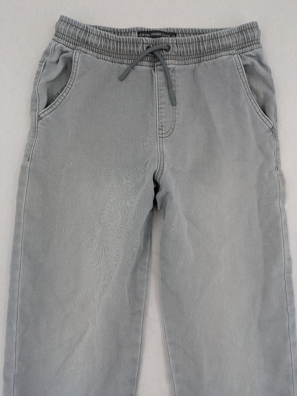 Denim & Co. grey jogger jeans with elastic waistband and ankle cuffs, cotton material.