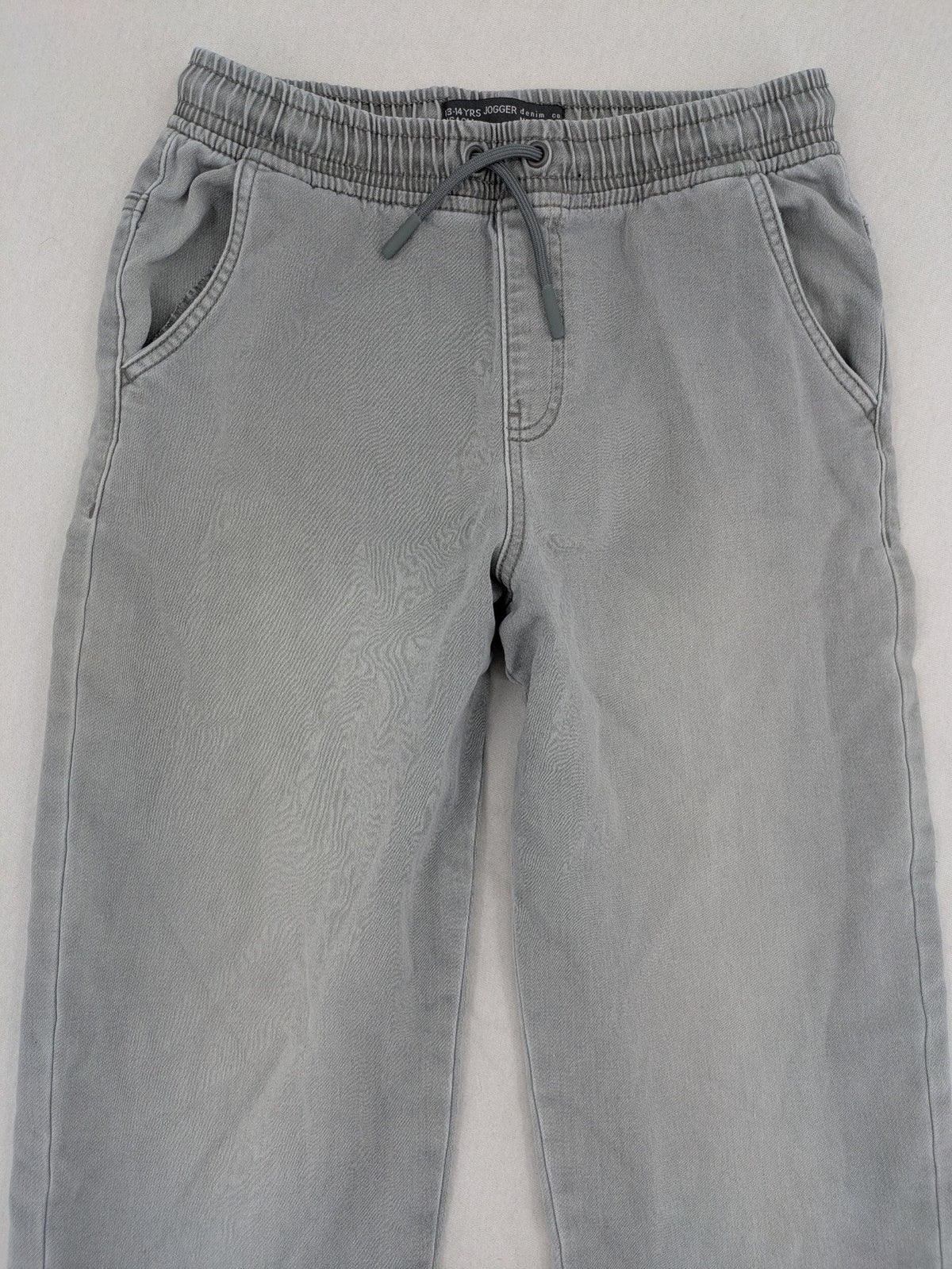 Denim & Co. grey jogger jeans with elastic waistband and ankle cuffs, cotton material.