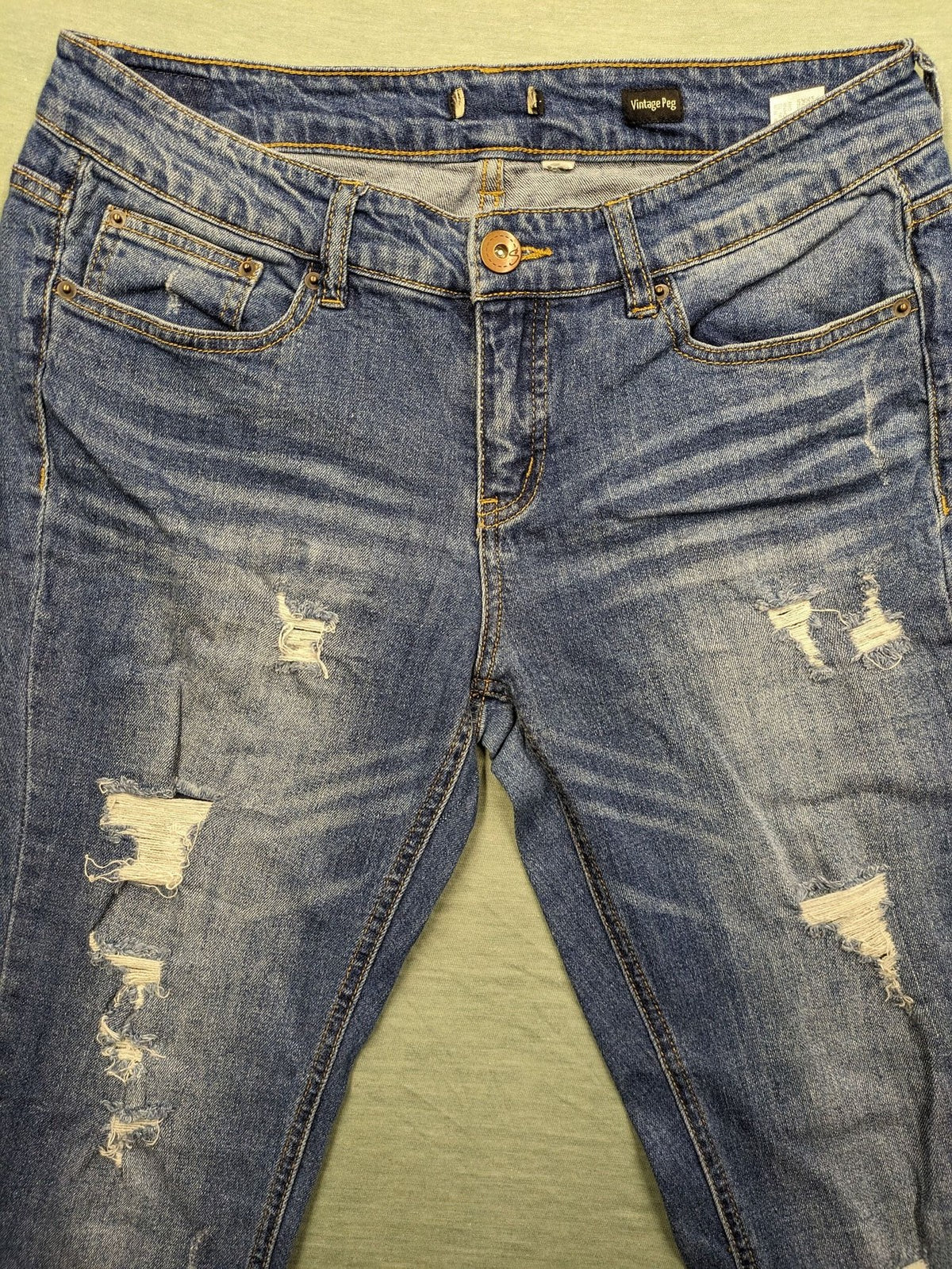Peg blue ripped straight jeans with distressed details and comfortable stretch material.