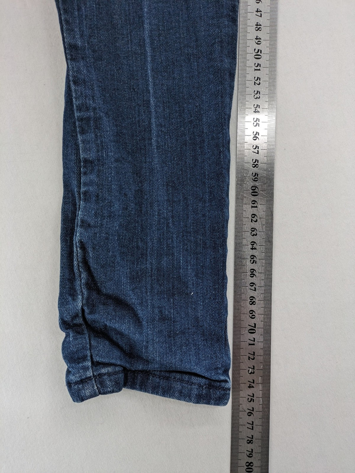 Place du Jour blue biker jeans with zippers, used-look wash, and star rivet detail.