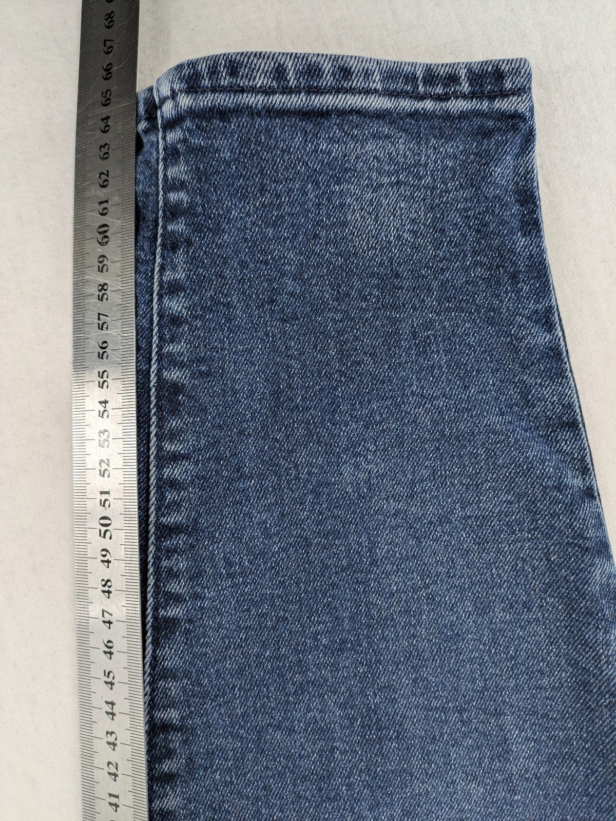 Levi's high waisted taper jeans dark blue 5-pocket design with zipper and stretch material.
