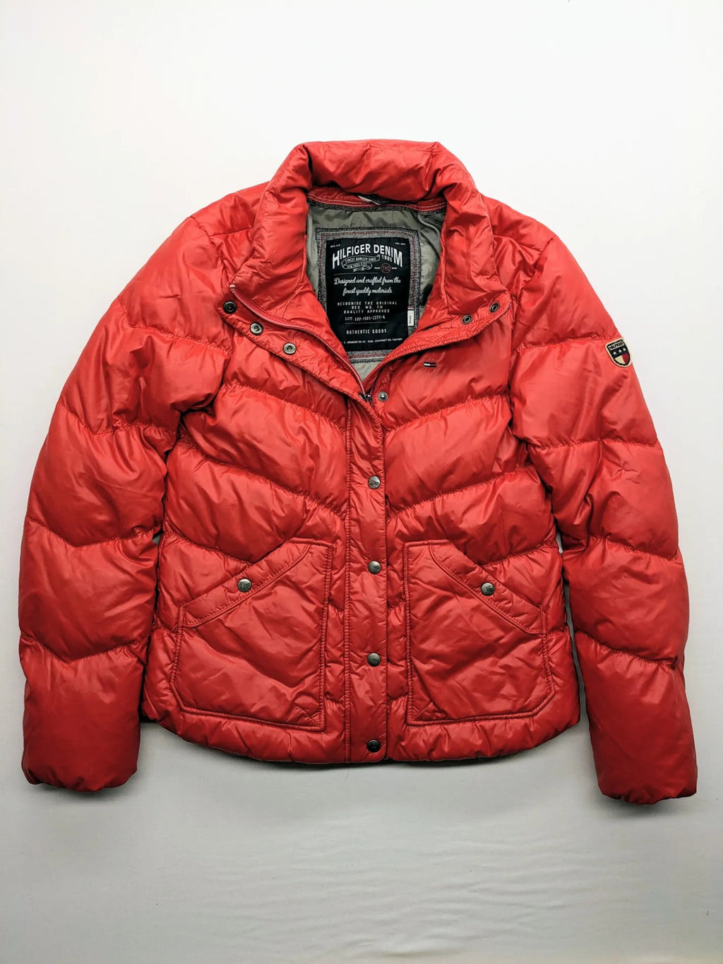 Hilfiger Denim red down jacket with quilted design, stand collar, and zip closure.