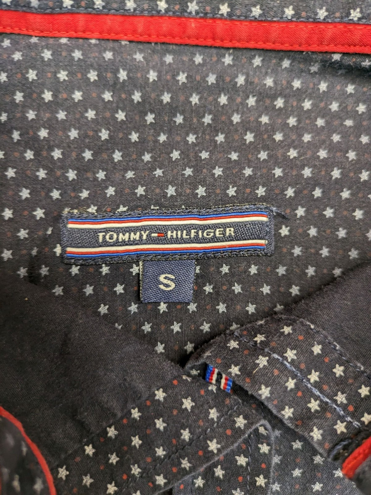 Tommy Hilfiger navy button-down shirt with white star pattern and embroidered flag logo.