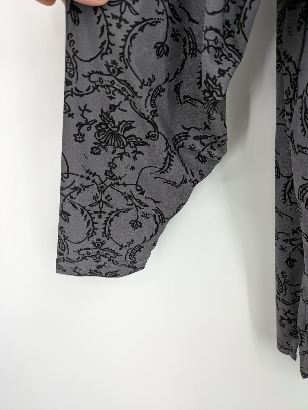 Yessica grey black floral pattern tunic top with round neckline and long sleeves.