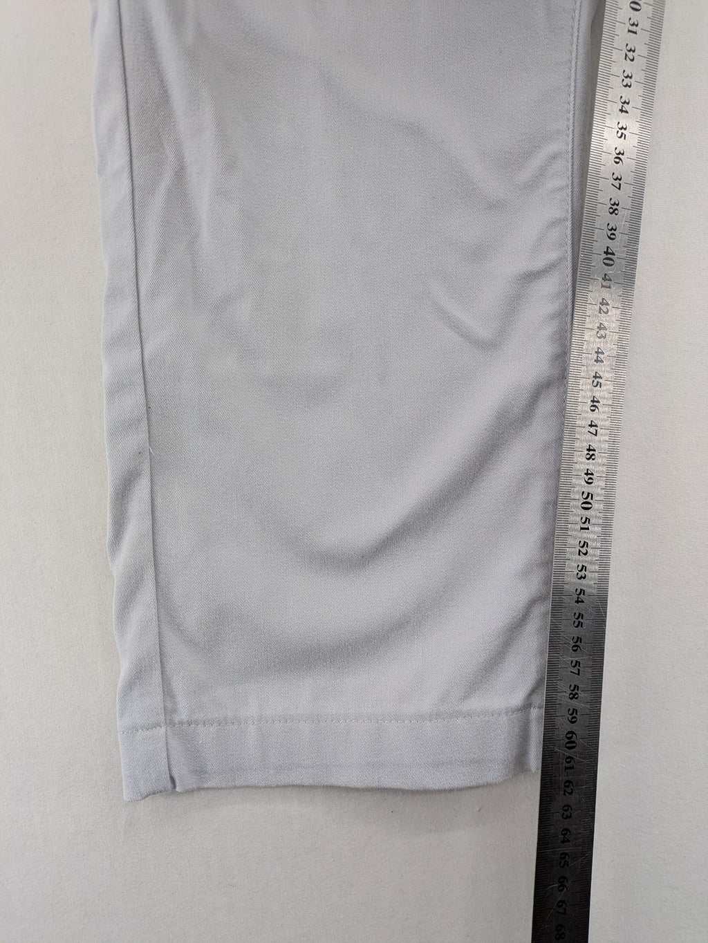 Chino grey capri pants five-pocket design with subtle embroidery and stretch cotton blend.