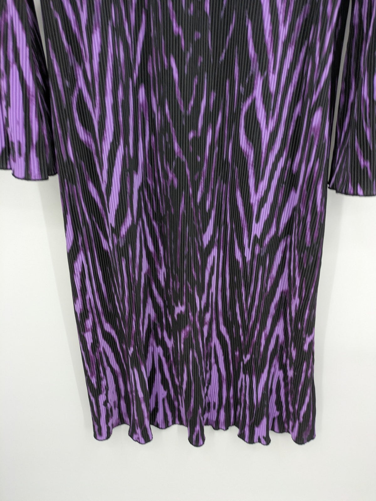 Untold black and purple pleated dress with animal print pattern and long sleeves.