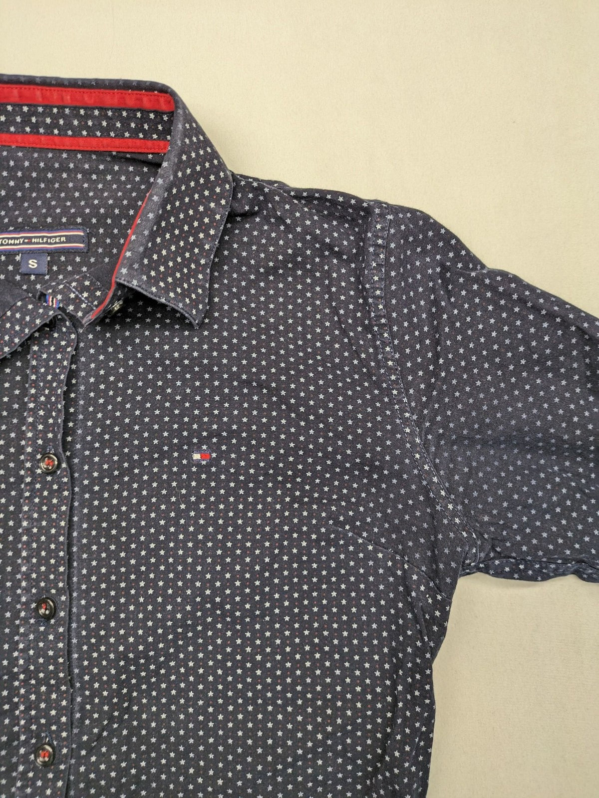 Tommy Hilfiger navy button-down shirt with white star pattern and embroidered flag logo.