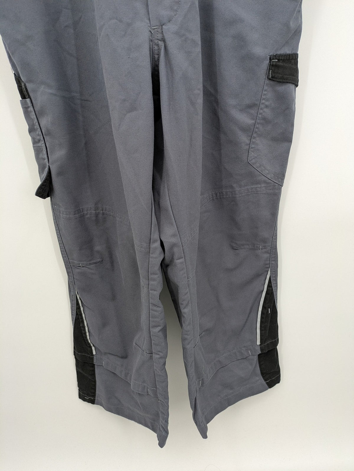 Works Wear grey and black overalls with adjustable straps and multiple pockets.