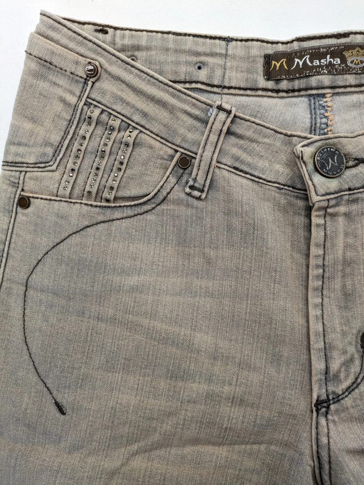 Masha khaki straight jeans with rhinestone embellishments and decorative stitching.