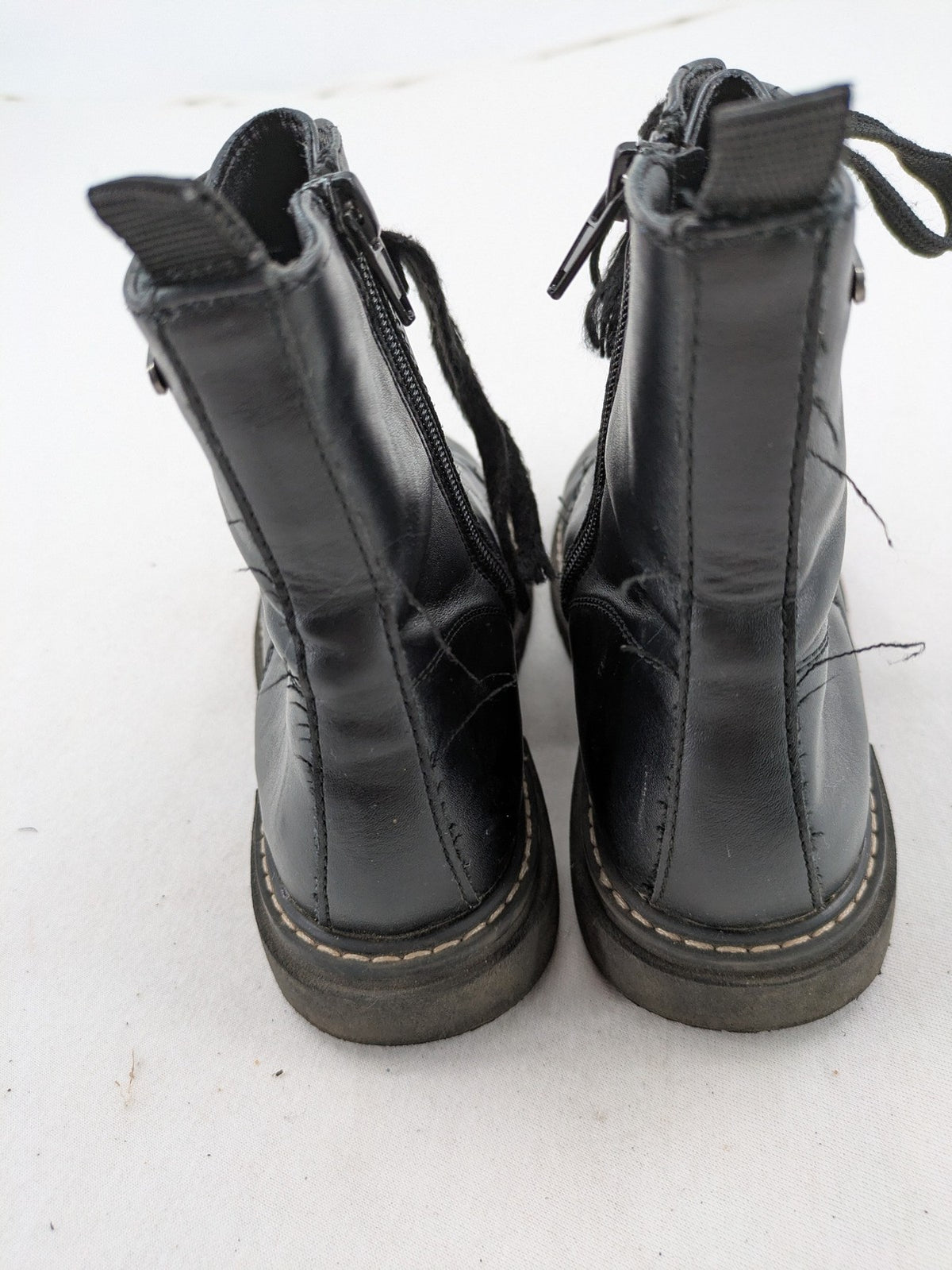 Esprit black combat boots for girls with lace-up front and side zipper detail.