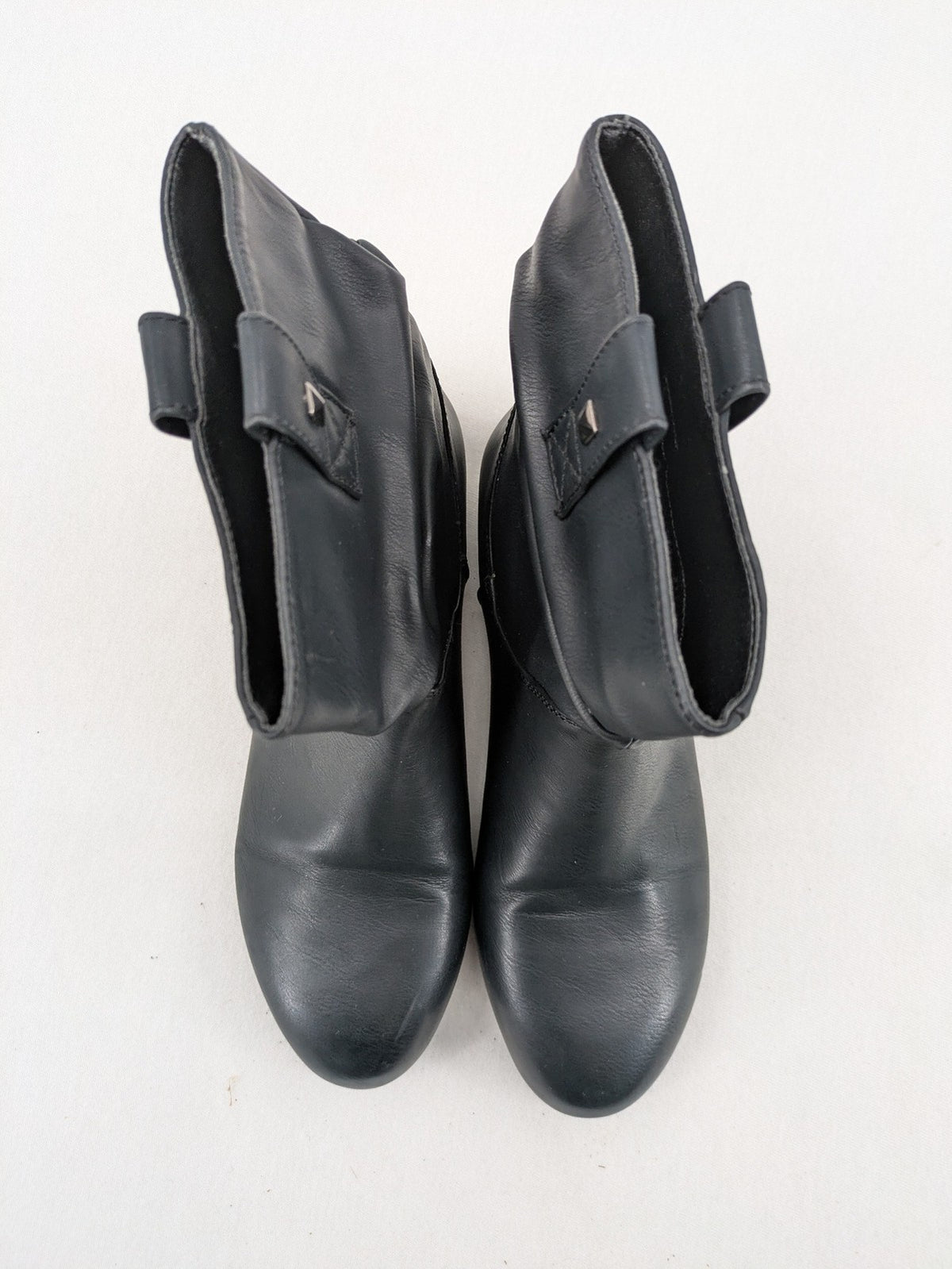 DAF black booties with decorative strap and studded details, made of faux leather.
