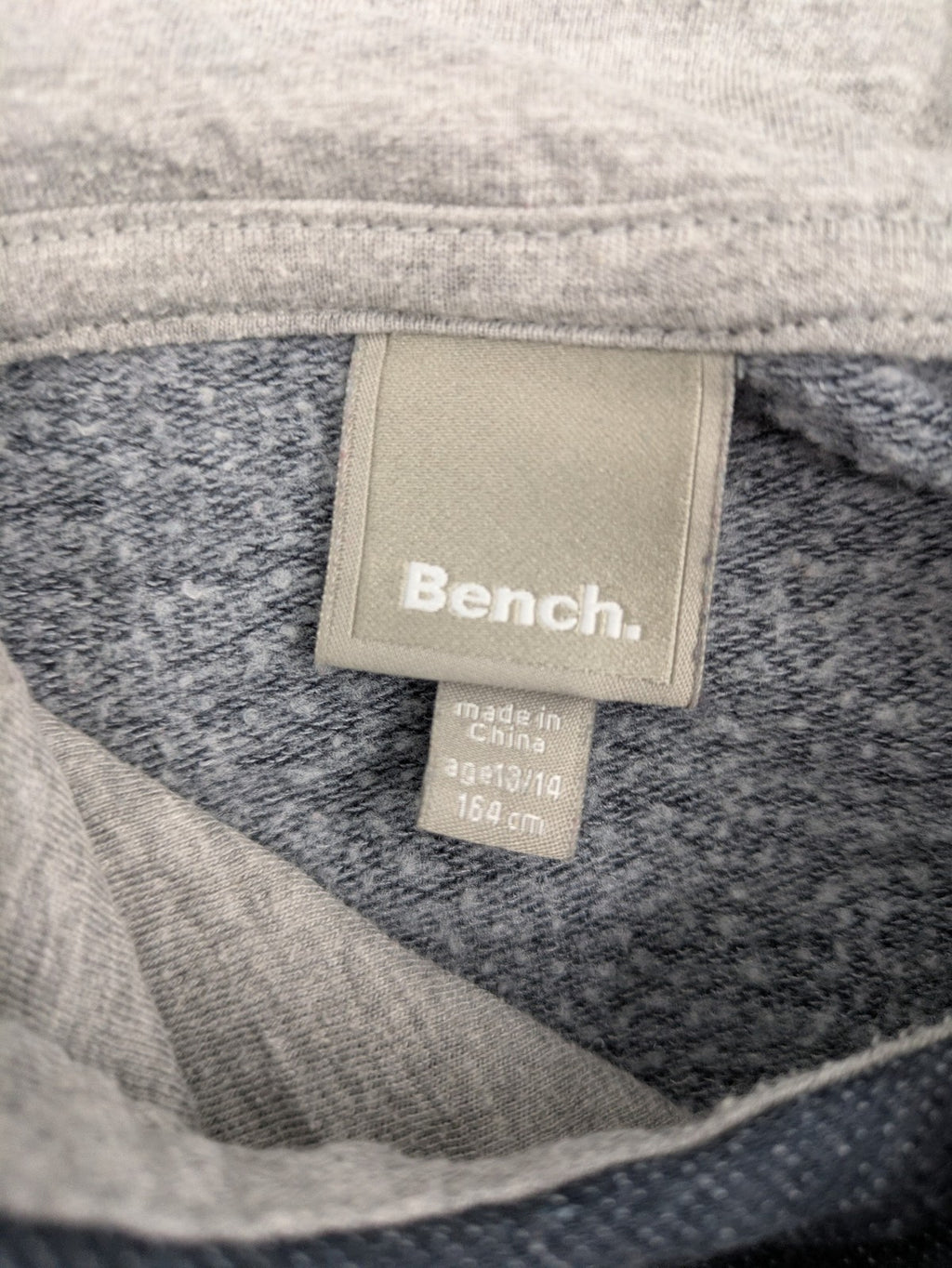 Bench hoodie dark grey with neon green logo and blue contrast stitching.