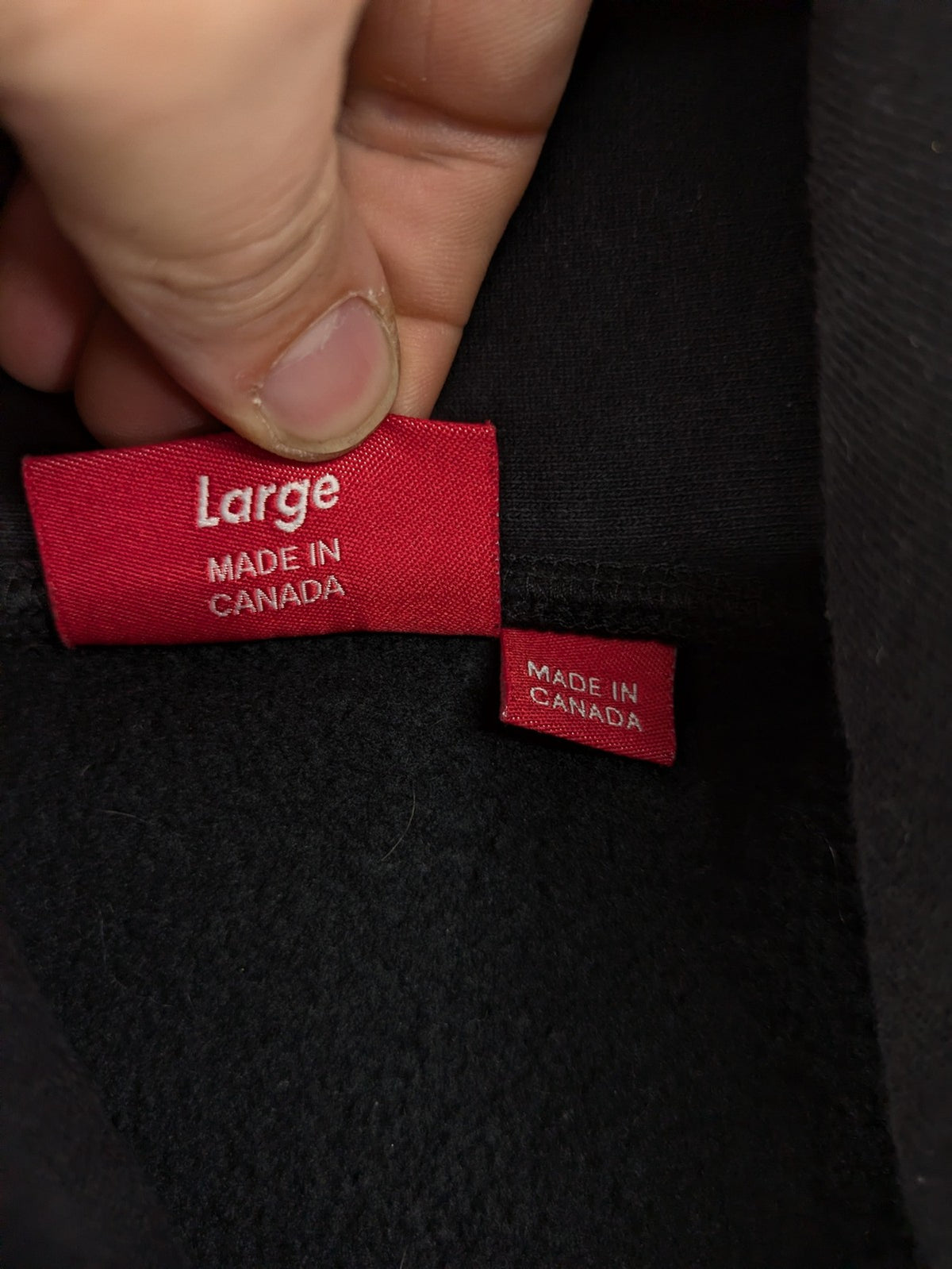 Supreme grey hoodie with embroidered small box logo, kangaroo pocket, and ribbed cuffs.
