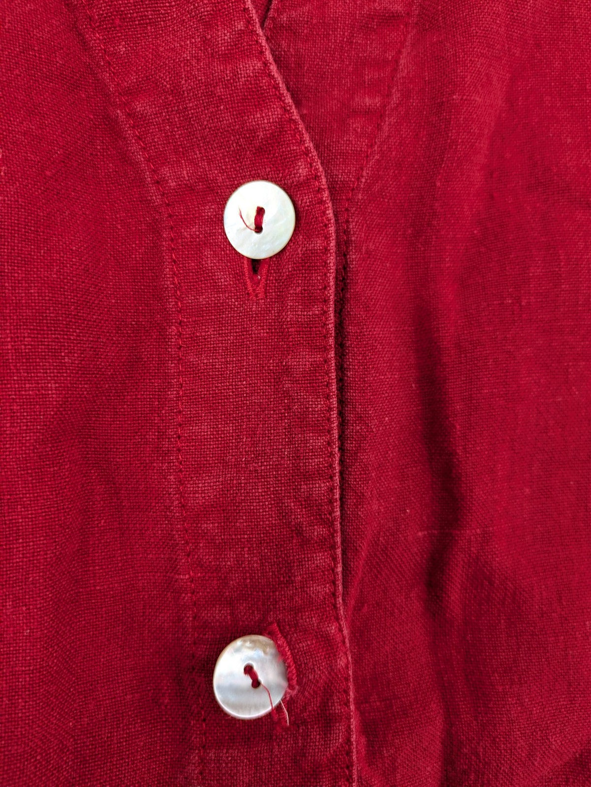 Deerberg red short-sleeve linen blouse with collar, button placket, and side slits.