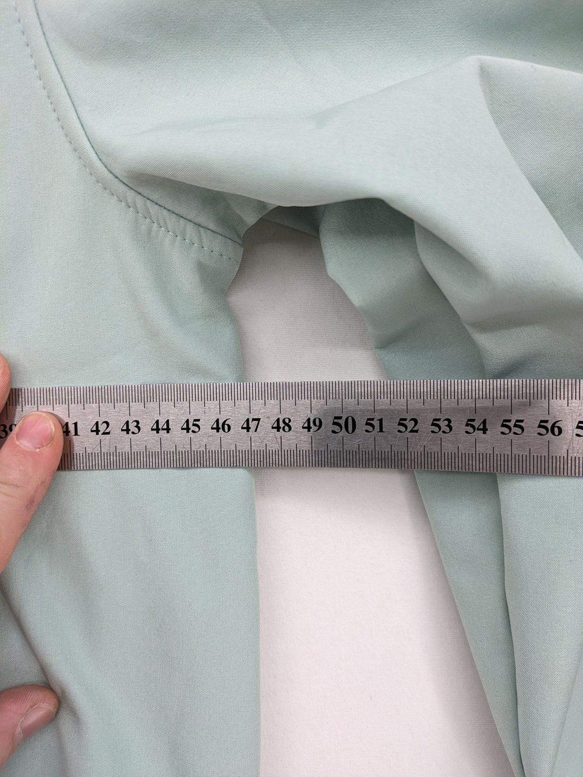 YFK outdoor jacket mint green softshell with dark grey fleece lining and hood.