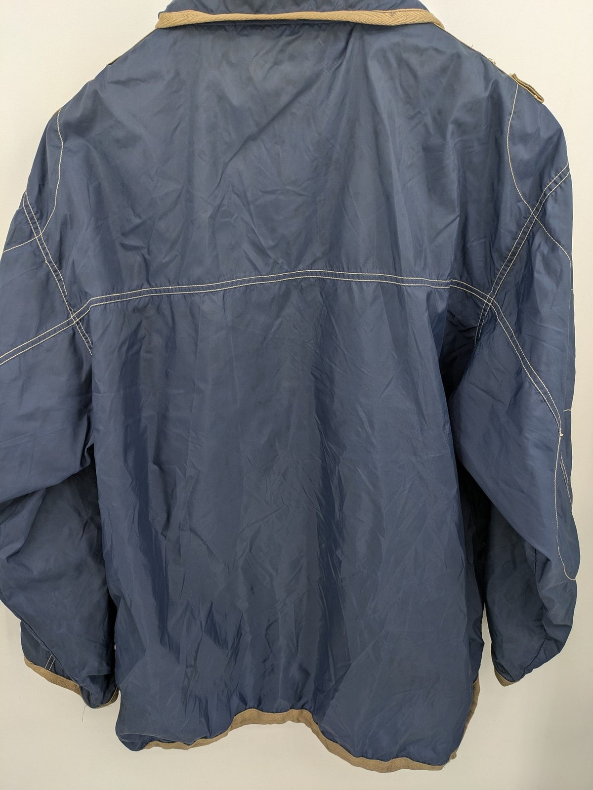 Knock Out navy blue jacket full zip nylon with brown accents and breathable mesh lining.