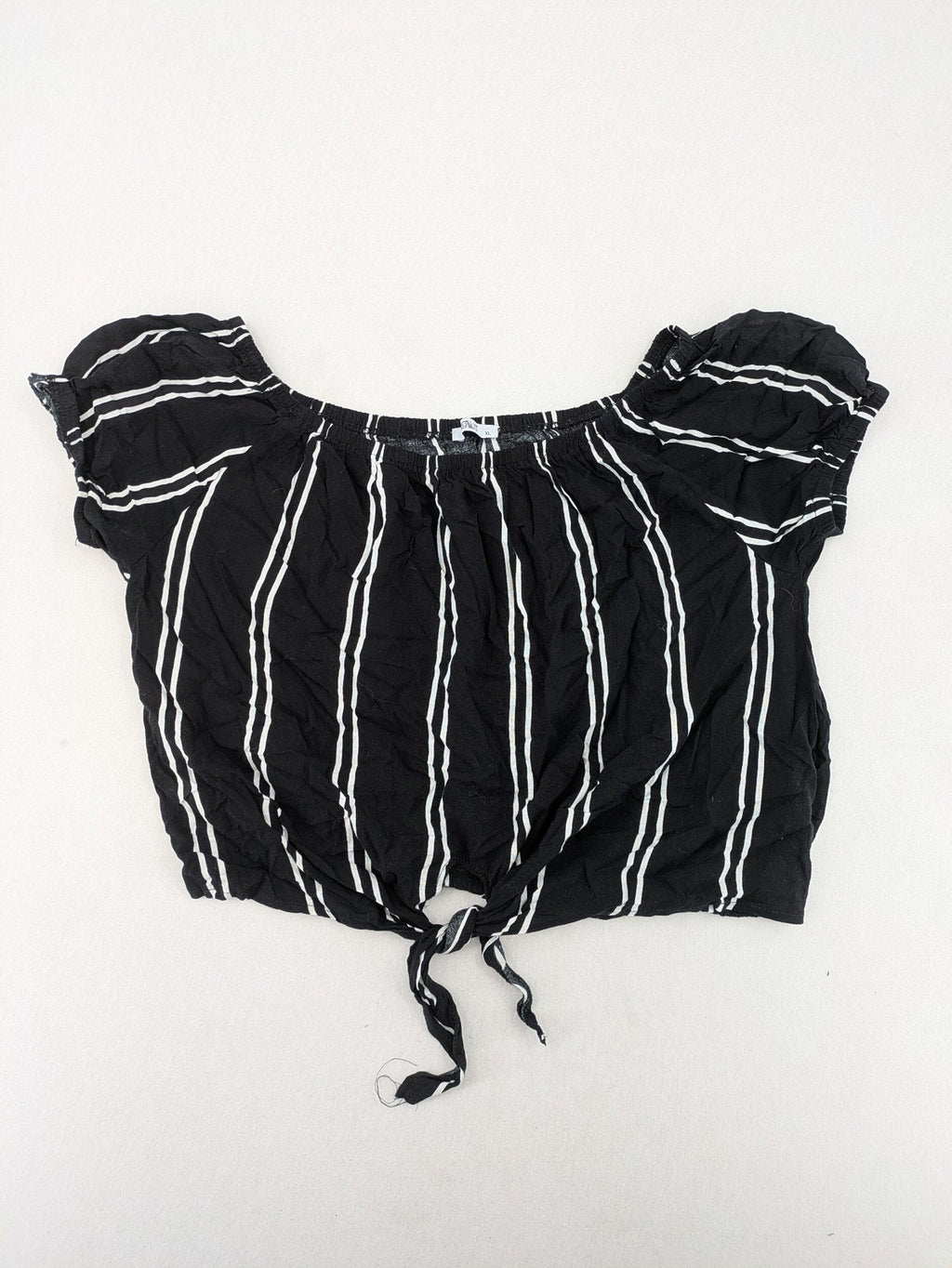 Hailys black and white striped crop top with front tie and off-shoulder design.