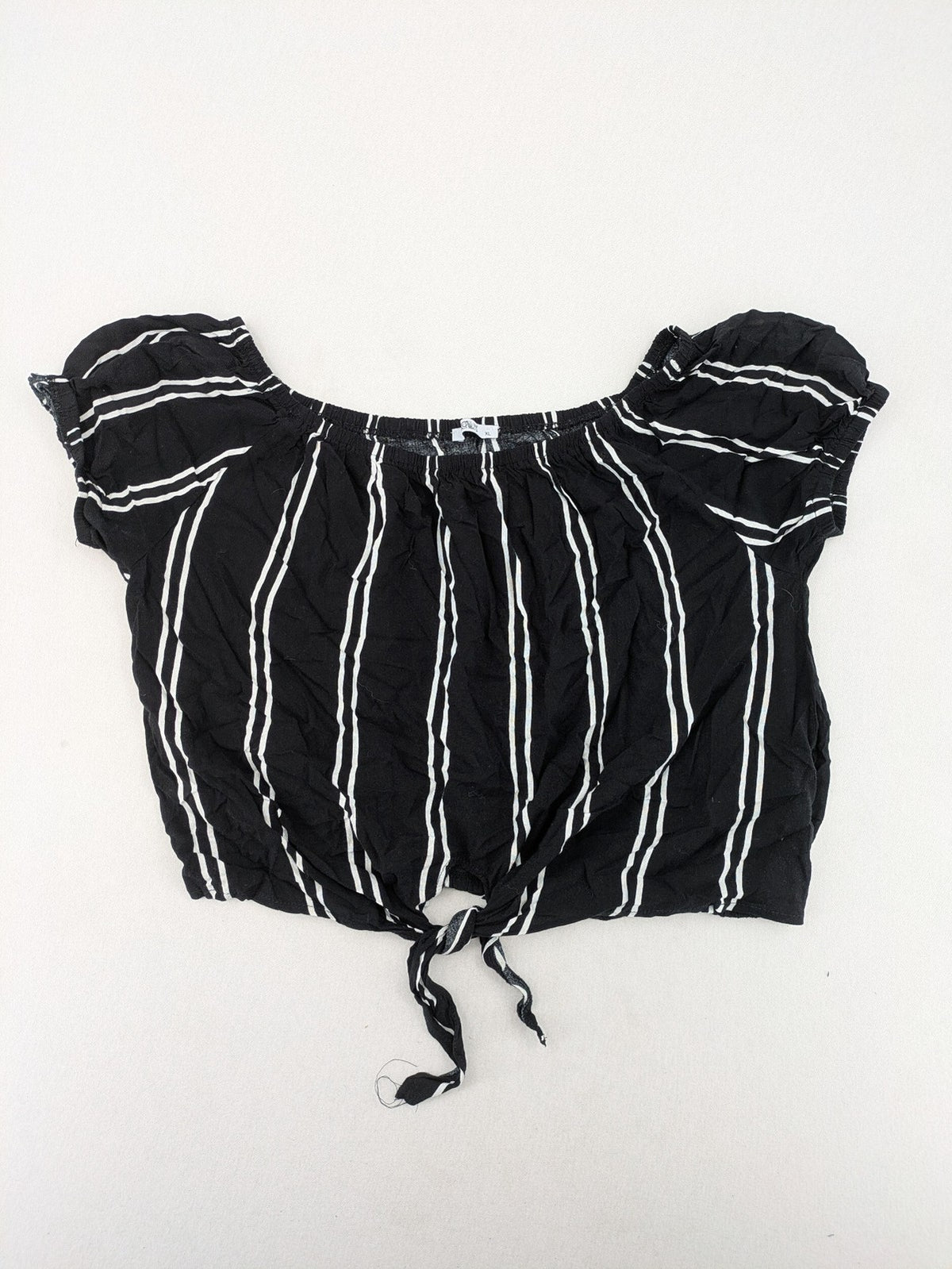 Hailys black and white striped crop top with front tie and off-shoulder design.