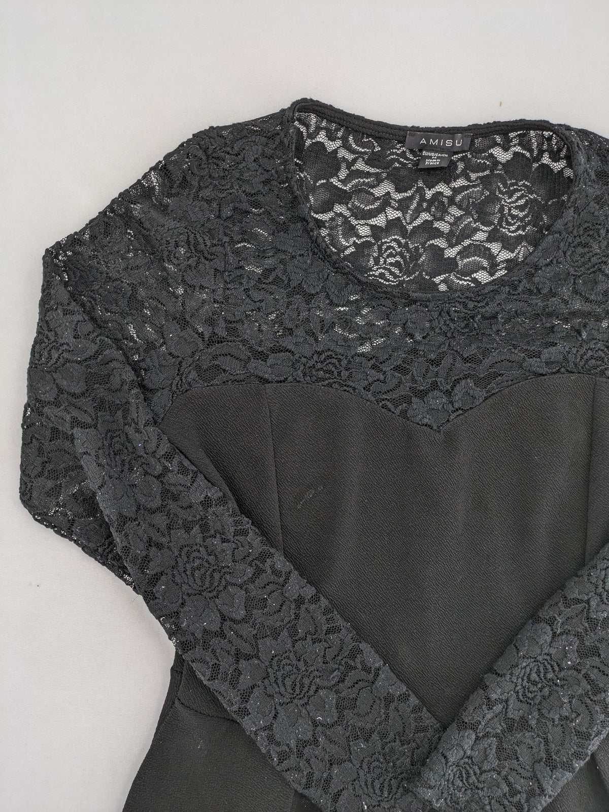 Amisu black peplum top with floral lace sleeves and delicate lace trim.