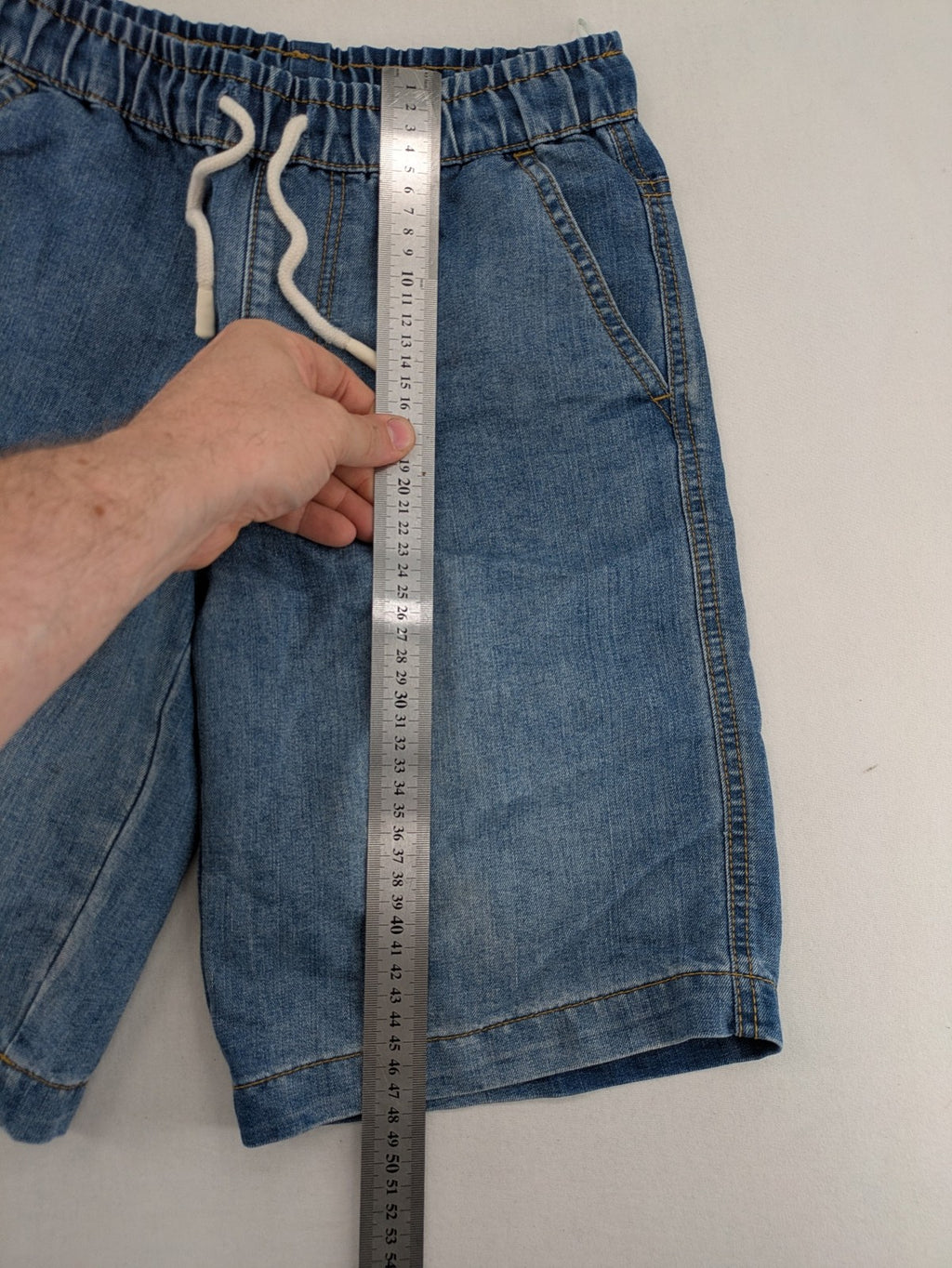 C&A blue denim shorts with elastic waistband and decorative drawstring, classic style.