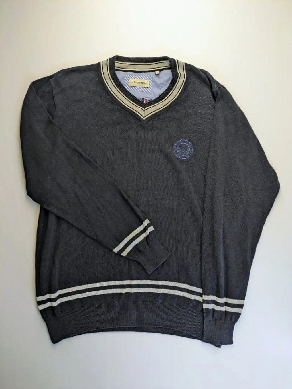 dunmore turtle neck jumper dark blue with striped trims and embroidered crest logo