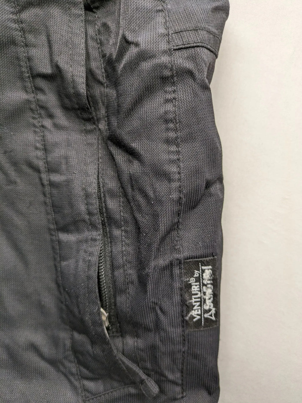 Schoffel black ski pants with adjustable straps, zip pockets, and snow gaiters.