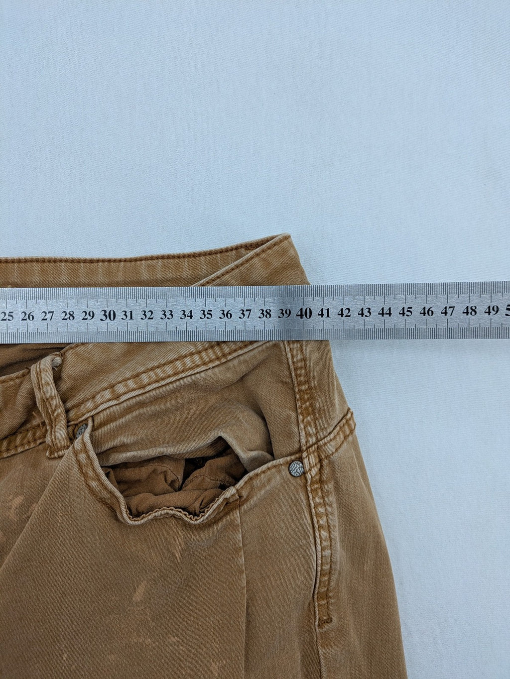 Buena Vista beige capri jeans with frayed hem and button fly detail.
