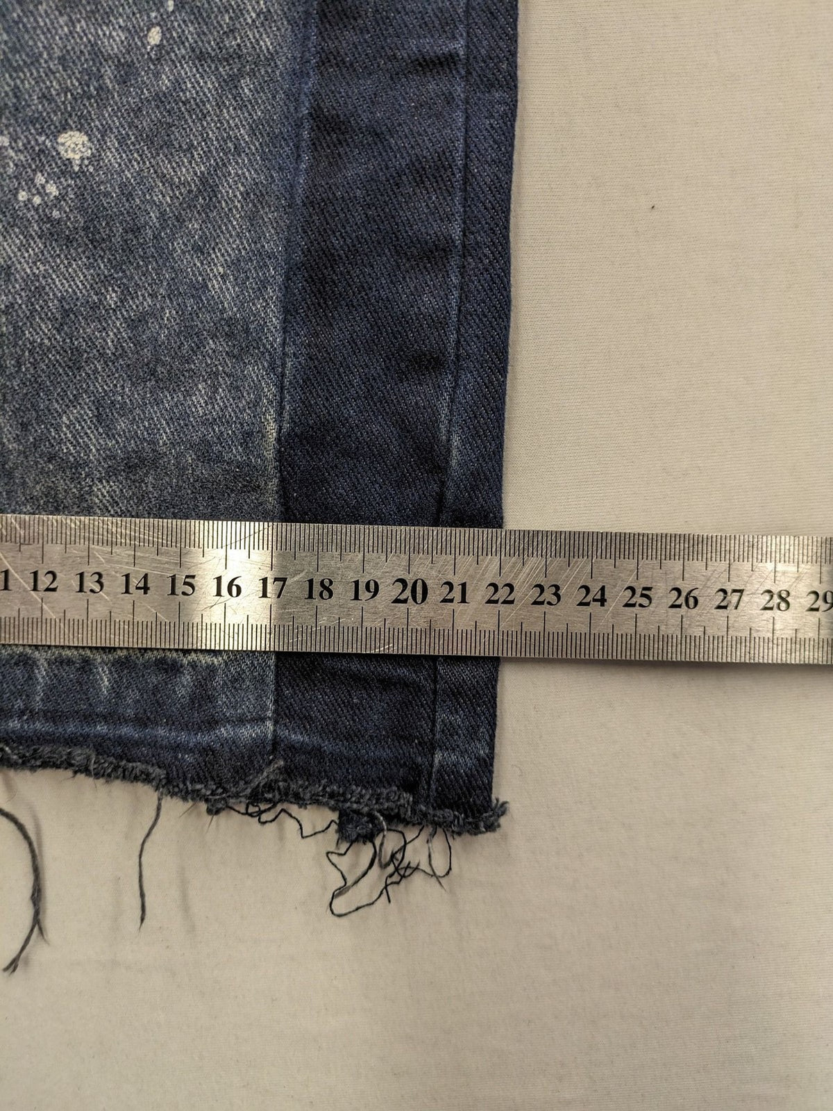 Reternity straight jeans blue black patchwork design with distressed details and frayed seams.