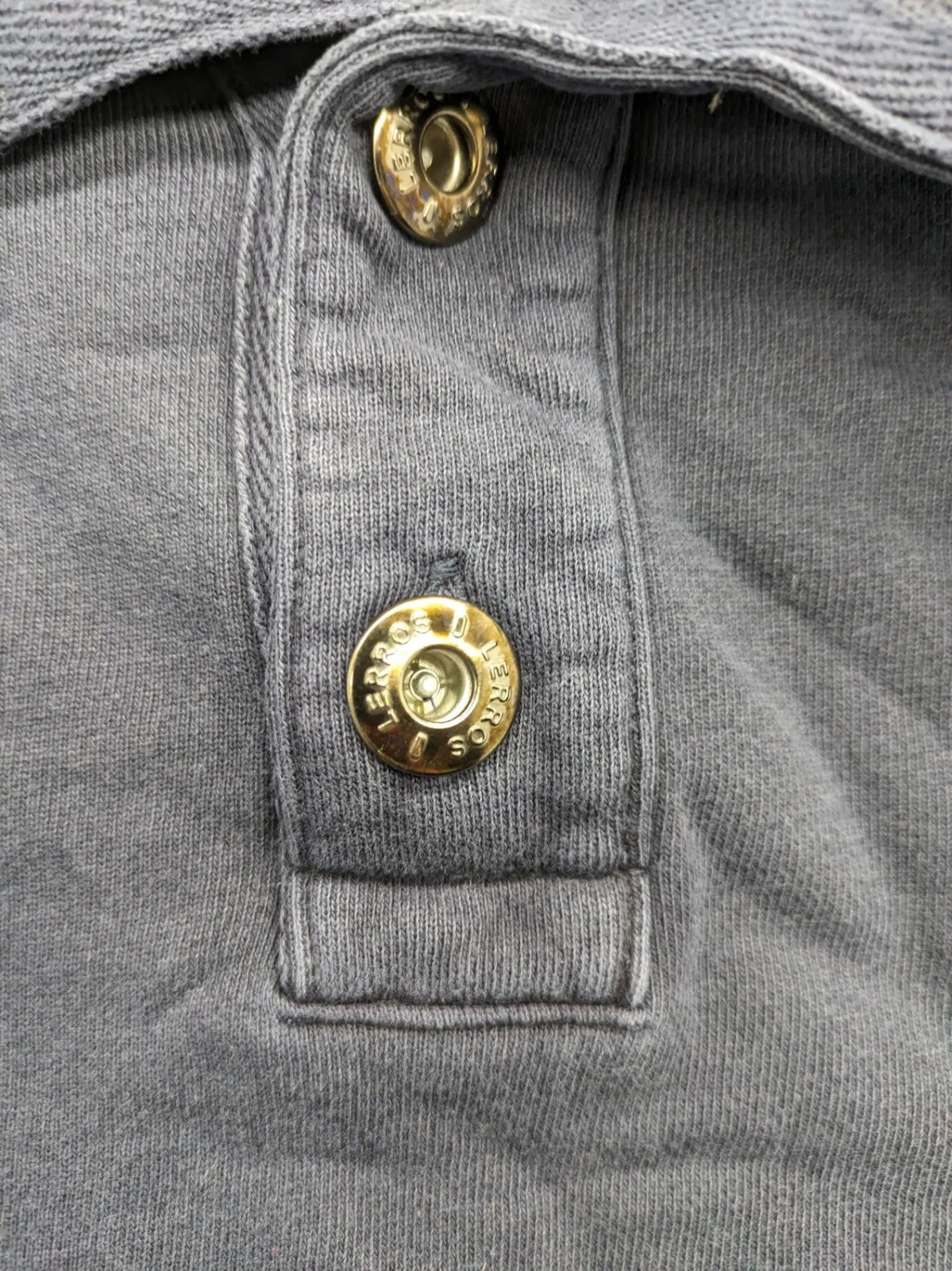 Lerros blue turtle neck jumper with stitched 'British Columbia' detail and button accents.