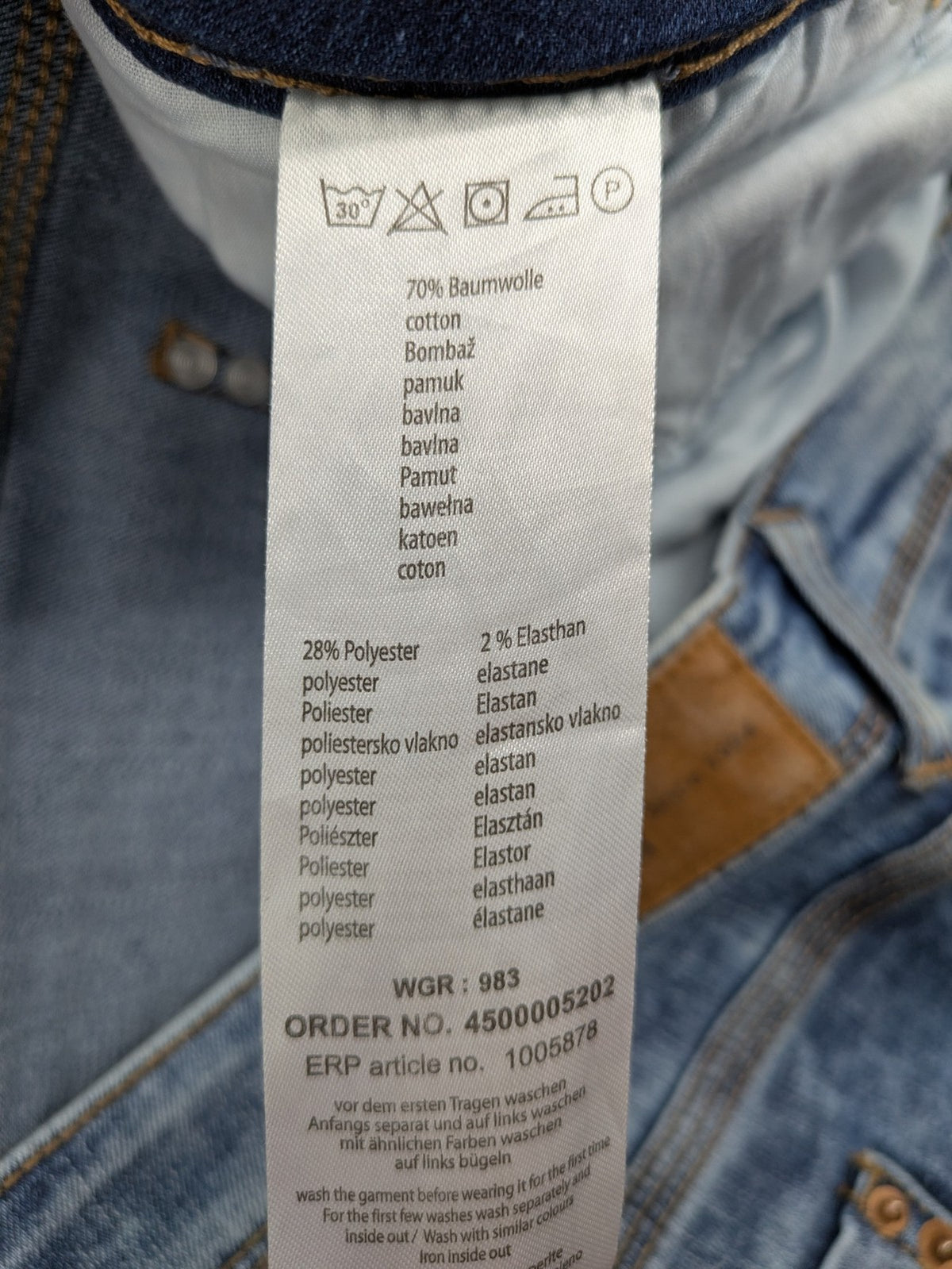 Janina blue slim fit jeans with acid wash, destroyed details, and button fly.