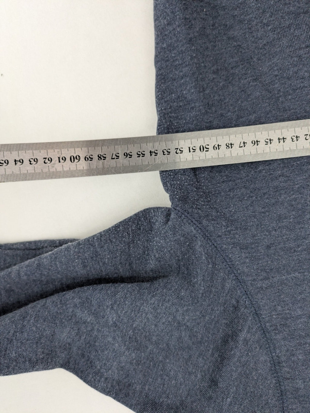 Tommy Jeans blue full zip hoodie with logo, adjustable hood, and kangaroo pockets.