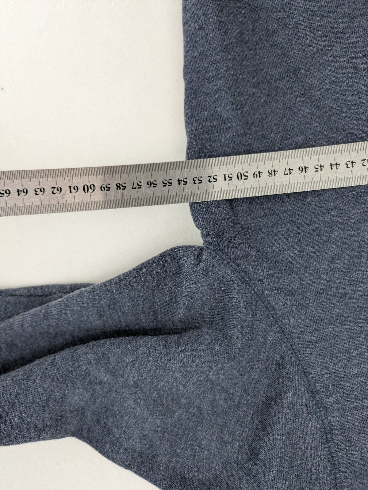 Tommy Jeans blue full zip hoodie with logo, adjustable hood, and kangaroo pockets.