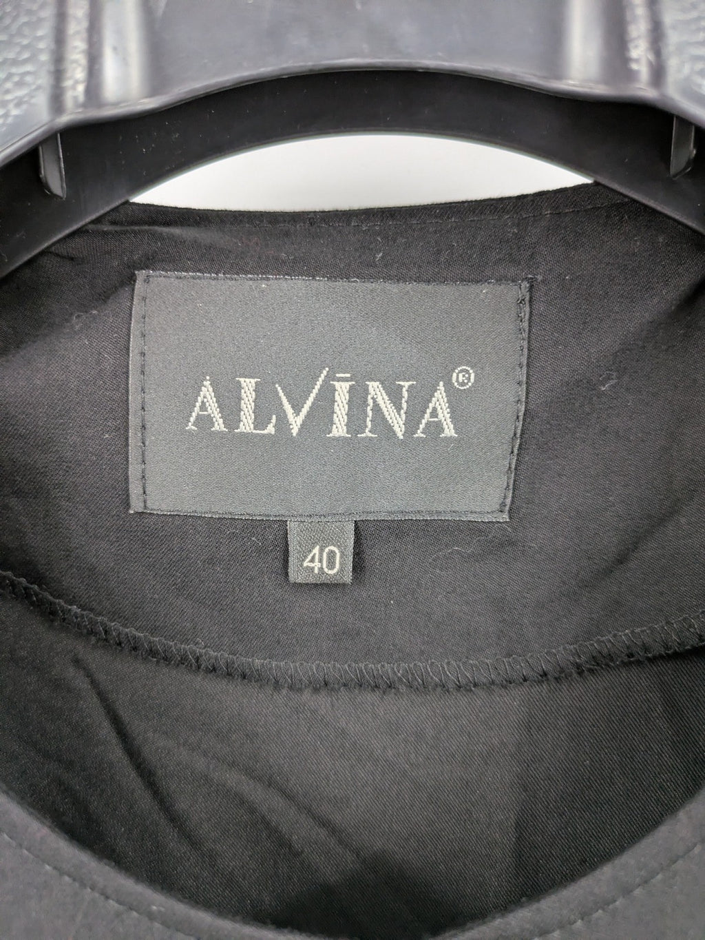 Alvina black trench coat with lace collar and gold buttons, belted waist design.