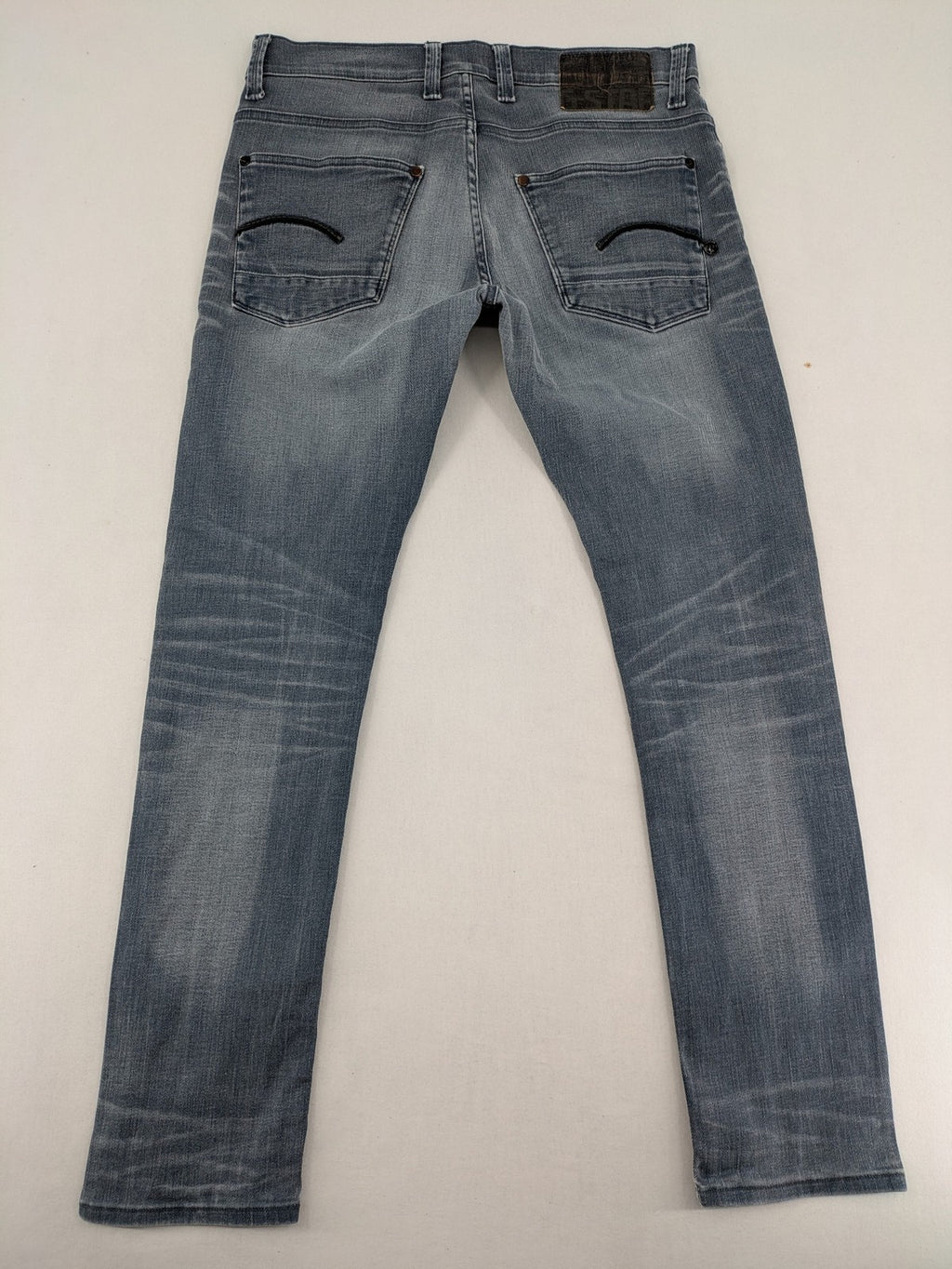 G-Star Raw grey denim straight jeans with classic button fly and subtle branding details.