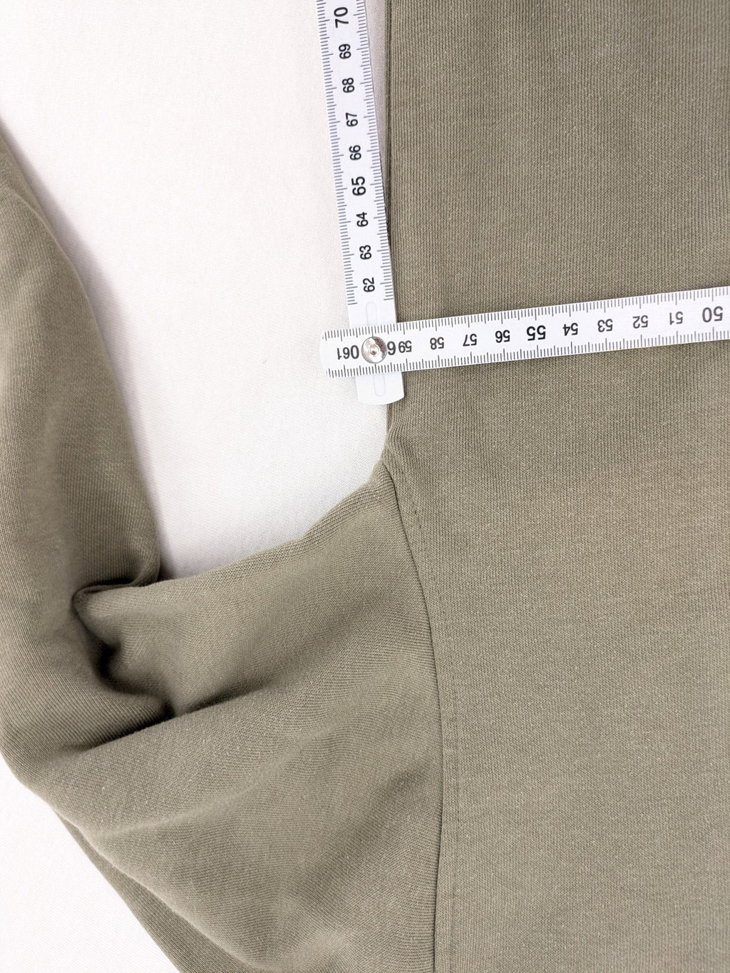 Naruto khaki turtle neck jumper featuring red Akatsuki cloud and Sharingan symbols.