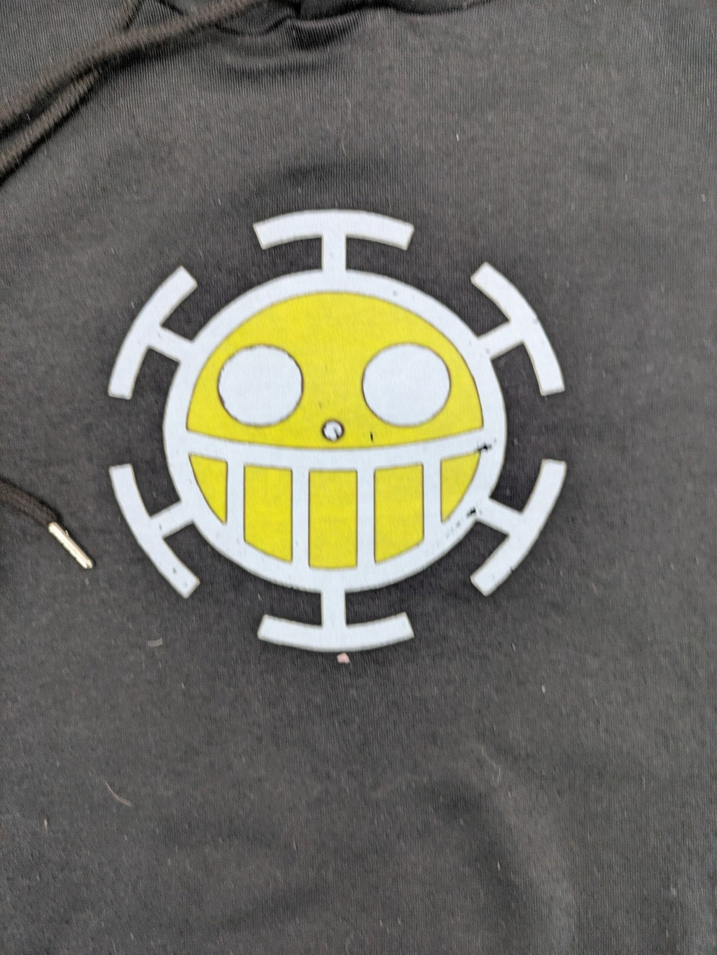 One Piece long hoodie black featuring Trafalgar Law's Jolly-Roger logo and drawstring hood.