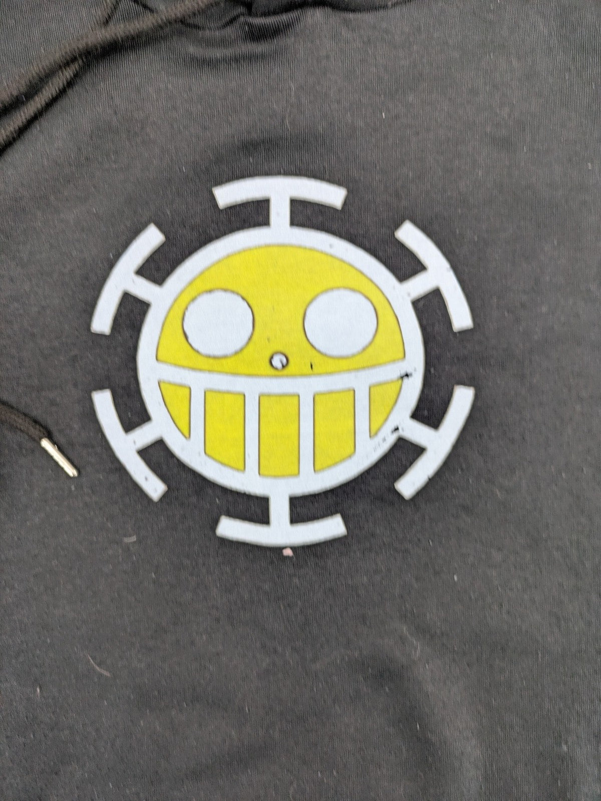 One Piece long hoodie black featuring Trafalgar Law's Jolly-Roger logo and drawstring hood.