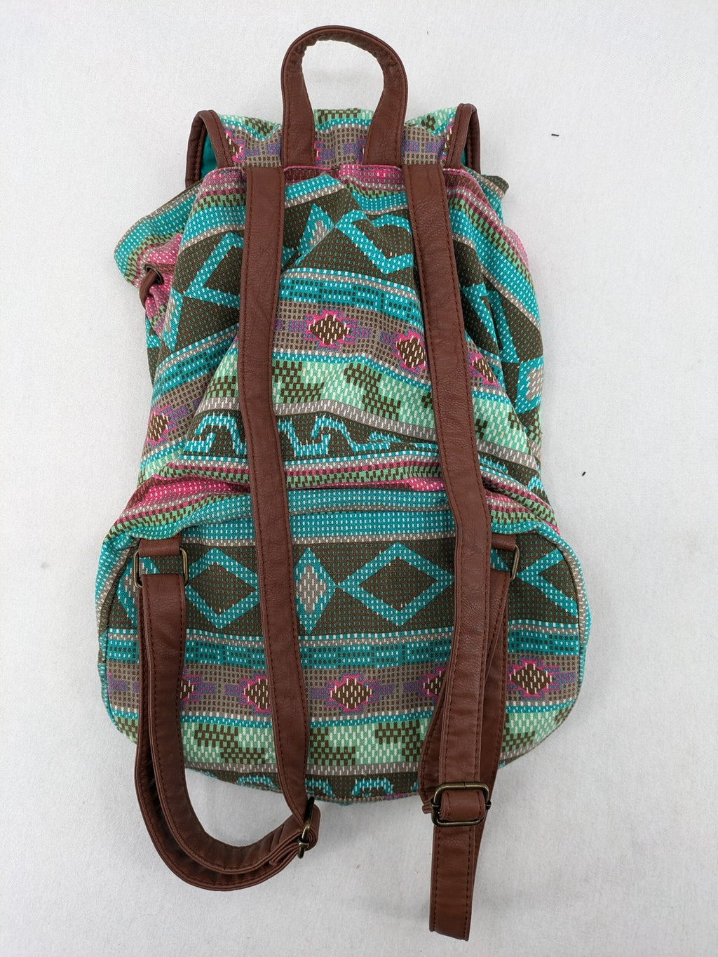 Boho multi backpack with vibrant Aztec tribal print and brown faux leather accents.